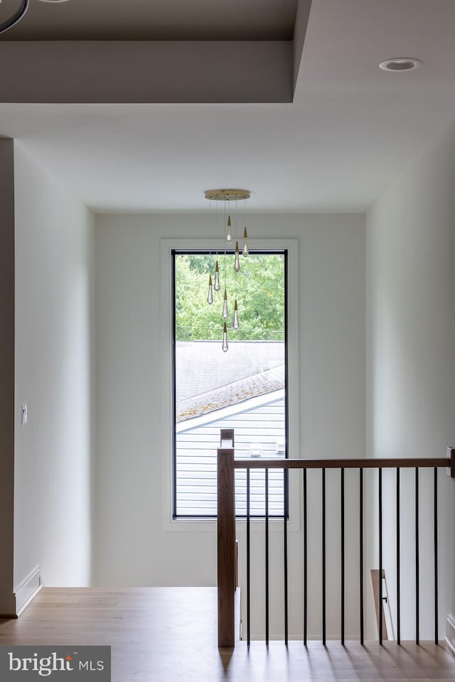 stairs with a notable chandelier and wood-type flooring