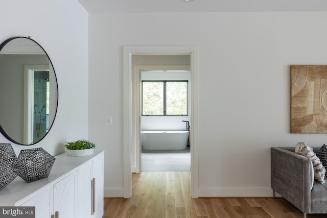 corridor with light hardwood / wood-style floors