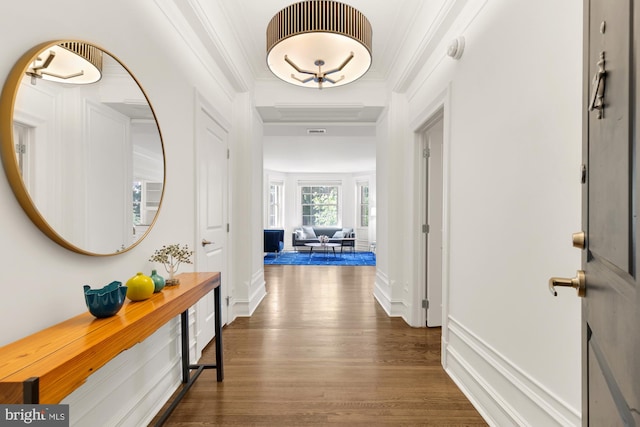 corridor featuring ornamental molding and dark wood-type flooring