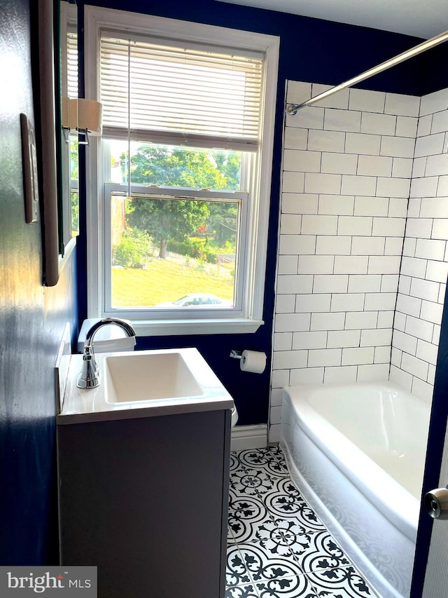 bathroom featuring vanity, tiled shower / bath combo, and tile patterned floors