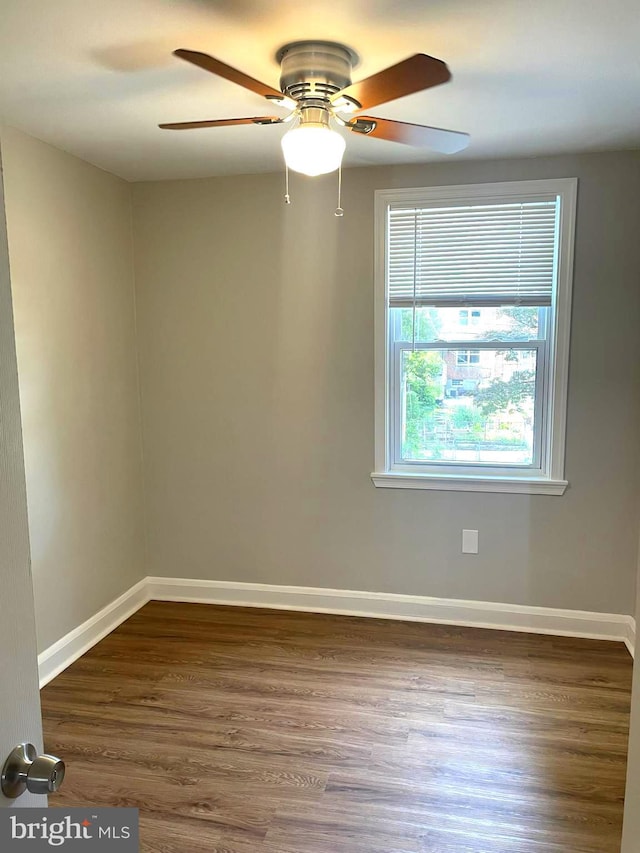 spare room with ceiling fan and hardwood / wood-style flooring