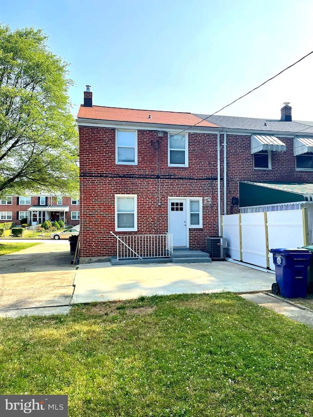 view of front of house featuring a front yard and central air condition unit