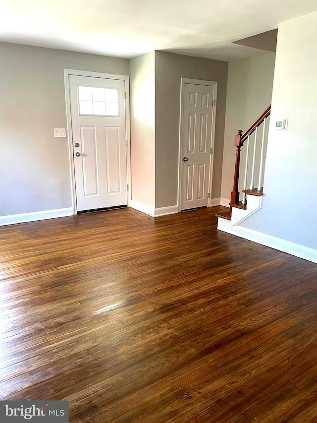 entryway with dark wood-type flooring