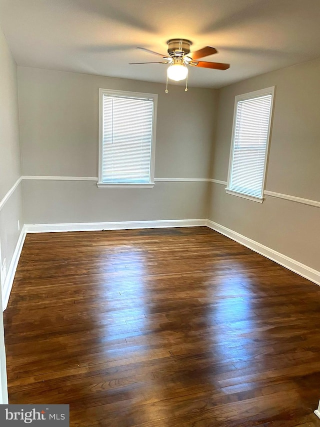 unfurnished room with ceiling fan and dark hardwood / wood-style floors