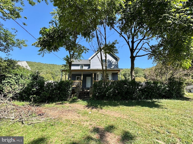 view of front of property with a porch and a front yard