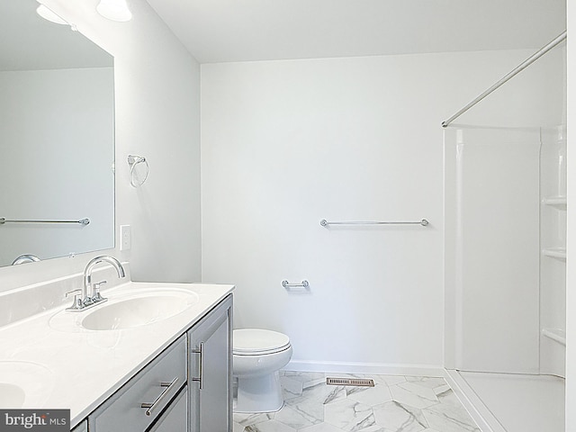 bathroom featuring walk in shower, baseboards, marble finish floor, and a sink