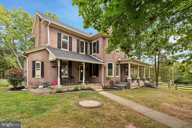 view of front facade with a front yard and covered porch