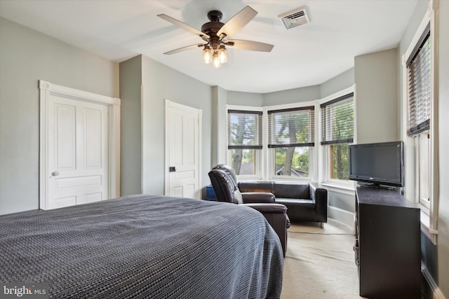 bedroom featuring light colored carpet and ceiling fan