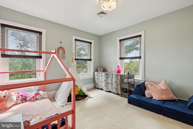 carpeted bedroom featuring multiple windows