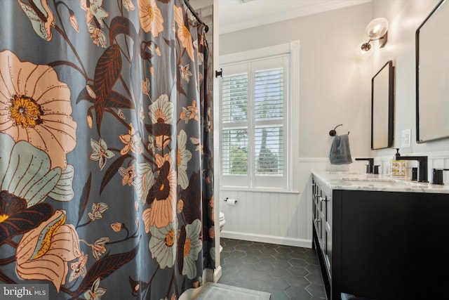 bathroom featuring ornamental molding, vanity, toilet, and plenty of natural light