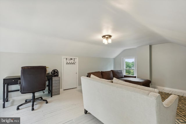 office area featuring light hardwood / wood-style floors and vaulted ceiling