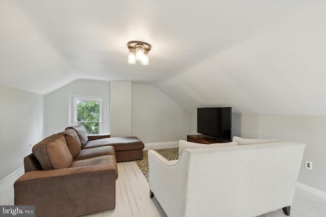 living room featuring light wood-type flooring and lofted ceiling