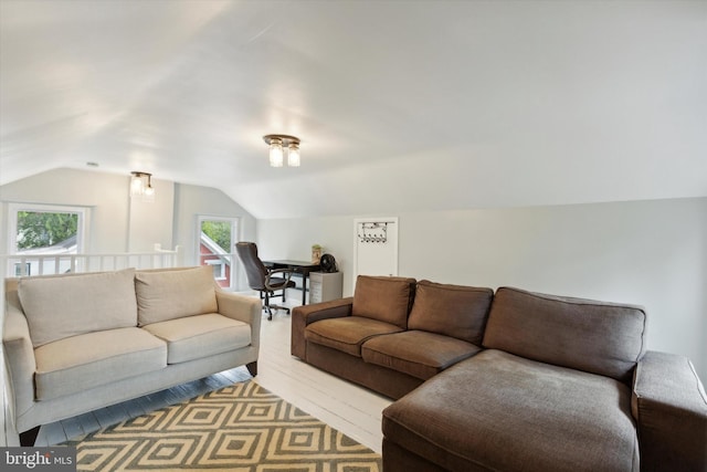 living room featuring light hardwood / wood-style floors and vaulted ceiling