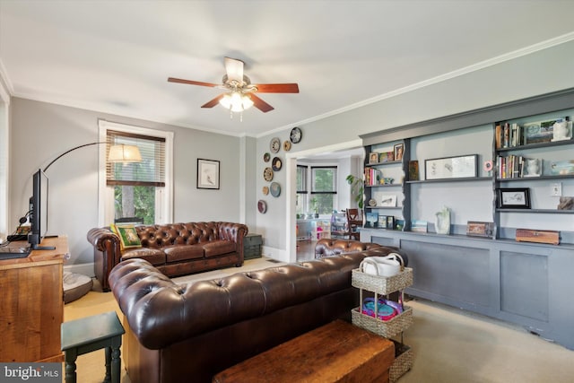 carpeted living room with a healthy amount of sunlight, ceiling fan, and ornamental molding