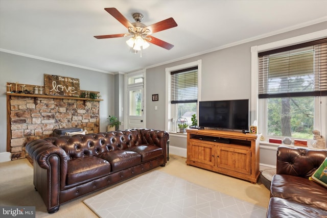 living room with ceiling fan, a fireplace, and ornamental molding