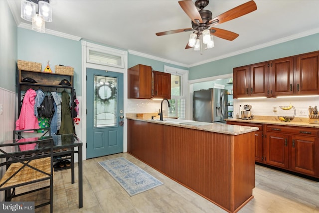 kitchen featuring light hardwood / wood-style floors, stainless steel fridge, ceiling fan, tasteful backsplash, and ornamental molding