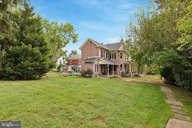 exterior space with covered porch and a front lawn