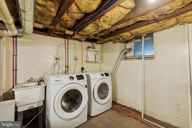 clothes washing area with sink and independent washer and dryer