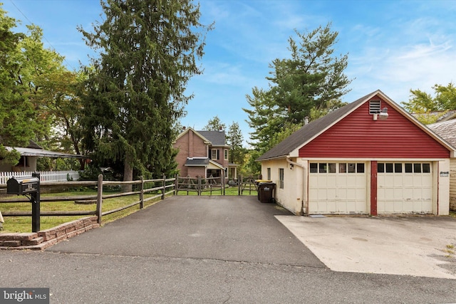 view of front of property with an outdoor structure and a garage