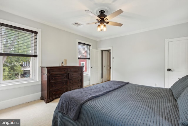 bedroom with ceiling fan, light colored carpet, and ornamental molding