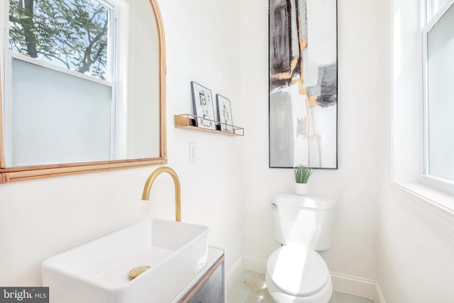 bathroom featuring vanity, toilet, and tile patterned floors