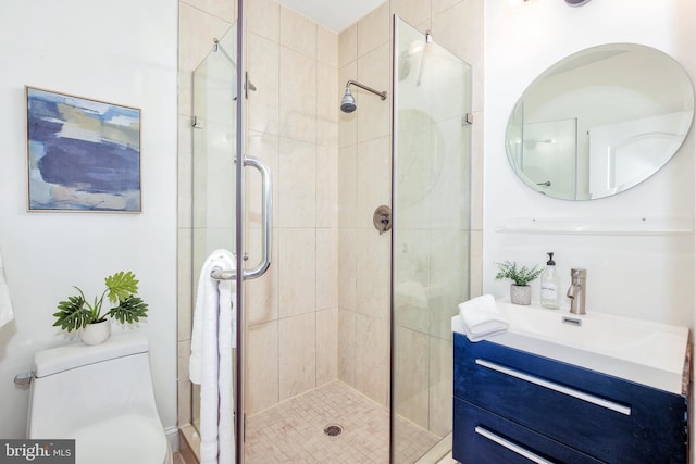 bathroom with walk in shower, vanity, and toilet