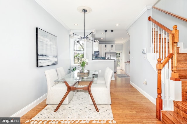 dining room with crown molding, light hardwood / wood-style flooring, and a wealth of natural light