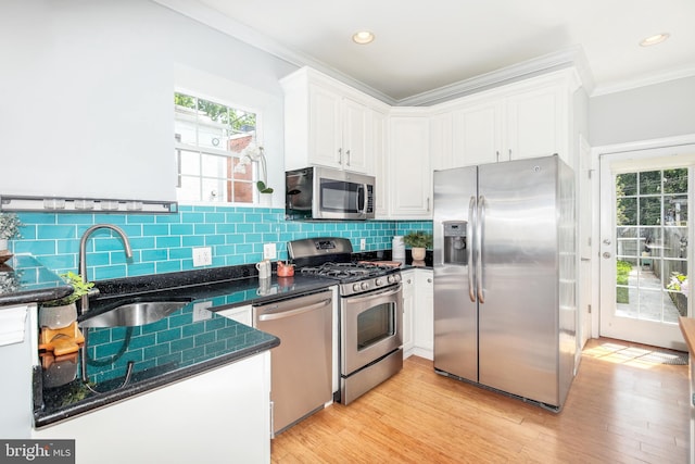 kitchen featuring sink, light hardwood / wood-style flooring, stainless steel appliances, and white cabinets