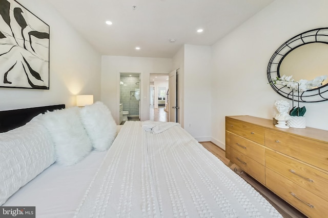 bedroom with light hardwood / wood-style flooring and ensuite bathroom