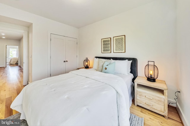 bedroom featuring light wood-type flooring and a closet