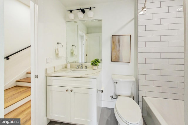 bathroom featuring wood-type flooring, vanity, and toilet