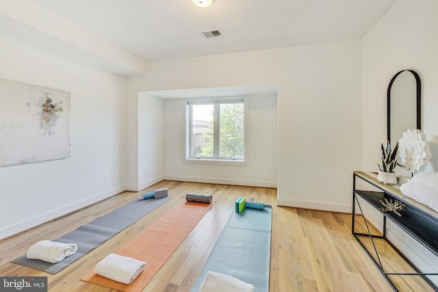 workout area with light wood-type flooring