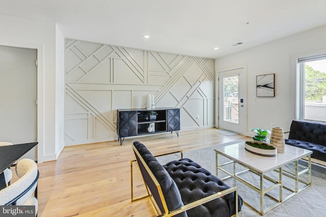 living room featuring wood-type flooring and plenty of natural light