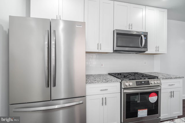 kitchen with stainless steel appliances and white cabinetry