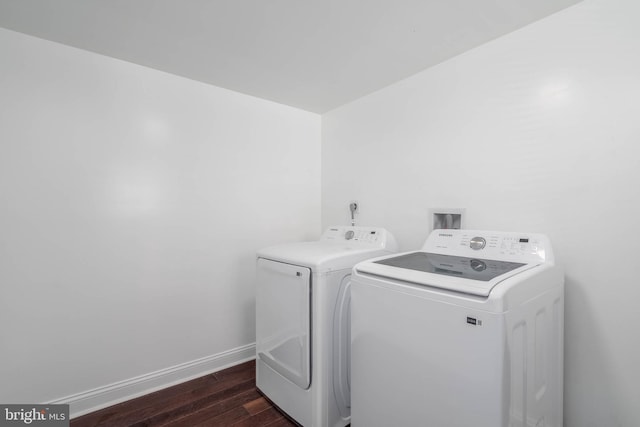 washroom featuring washing machine and dryer and dark wood-type flooring