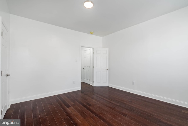 empty room with dark hardwood / wood-style floors