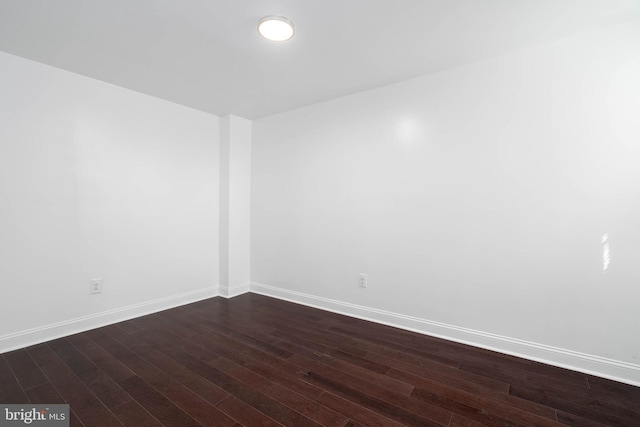 unfurnished room with dark hardwood / wood-style floors