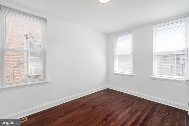 spare room featuring dark hardwood / wood-style flooring