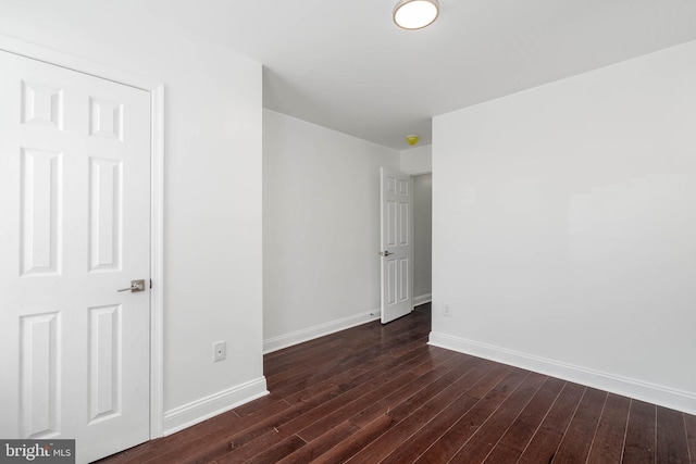 spare room with dark hardwood / wood-style floors