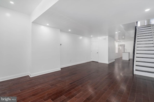 unfurnished living room with dark hardwood / wood-style flooring