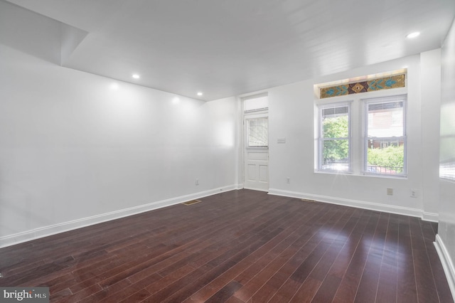 empty room featuring dark hardwood / wood-style flooring