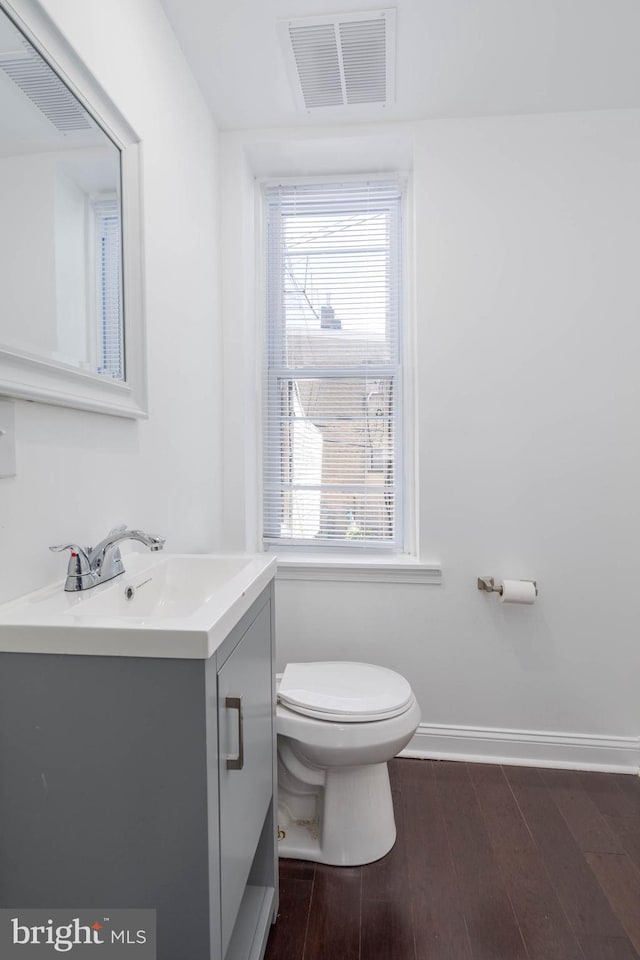 bathroom featuring vanity, toilet, and hardwood / wood-style floors