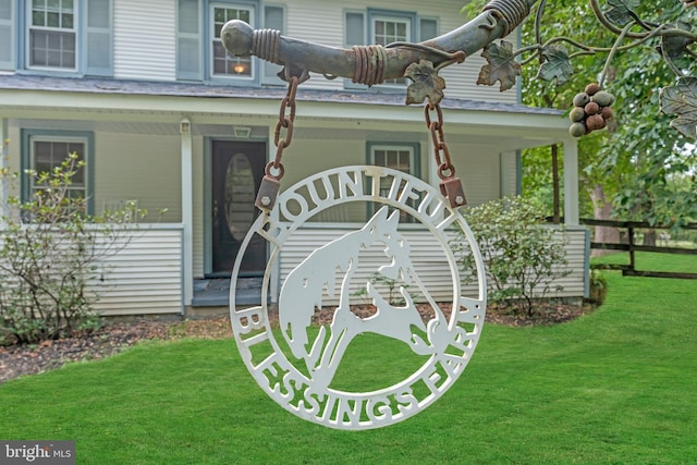 doorway to property featuring a lawn and covered porch