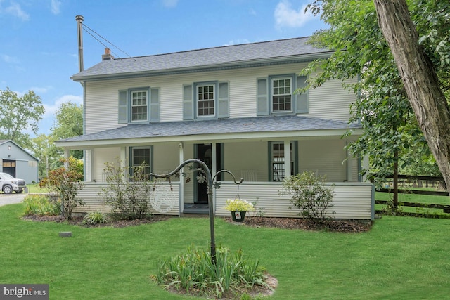 view of front of property with a front yard and a porch