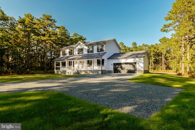 view of front of home featuring a garage and a front lawn