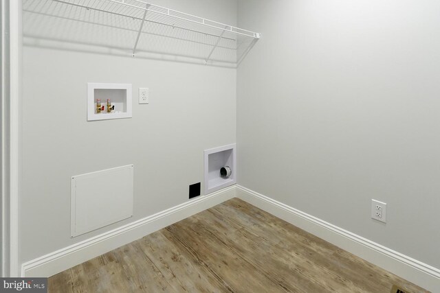 clothes washing area featuring wood-type flooring, electric dryer hookup, and hookup for a washing machine