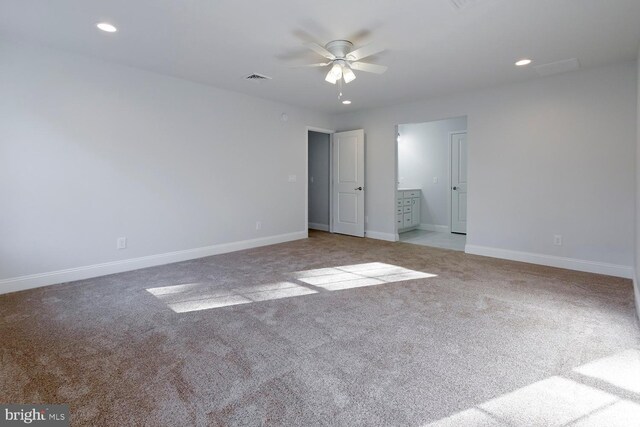 unfurnished room with ceiling fan and light colored carpet