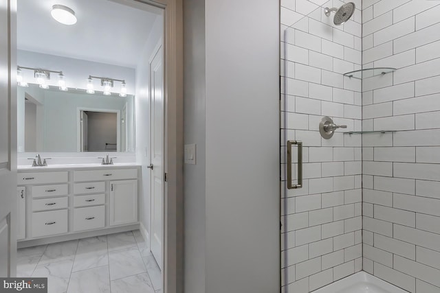 bathroom with vanity and tiled shower