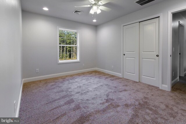 unfurnished bedroom featuring carpet floors, ceiling fan, and a closet