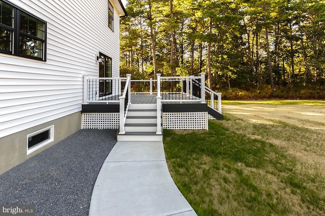 wooden deck featuring a yard